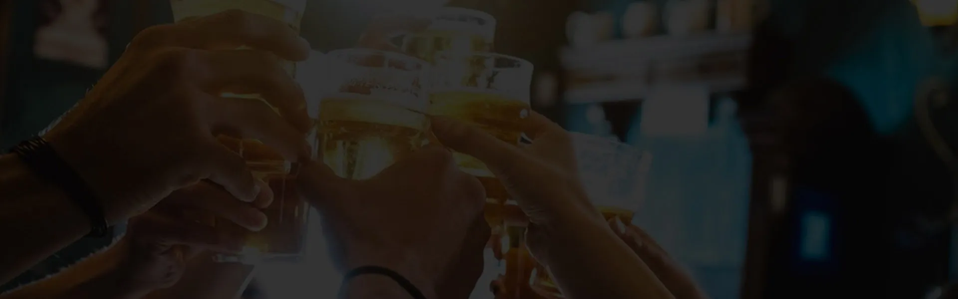 Friends raising beer glasses together